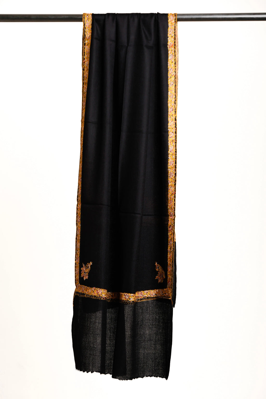 Black shawl with gold border and patterns on a white background