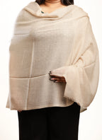 Beige shawl draped over a person on a white background