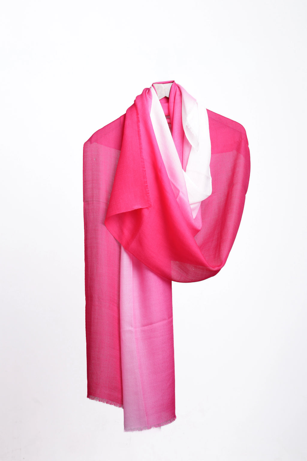 A lightweight scarf with a vibrant pink ombre gradient transitioning to white, draped elegantly on a white background.
