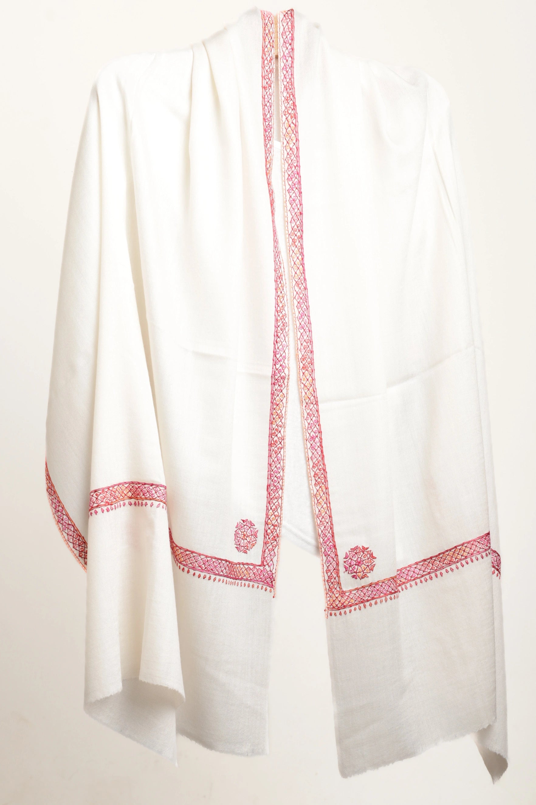 White garment with red embroidery on a white background