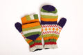 Colorful striped mittens on a white background
