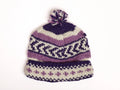 Knitted hat with purple and white pattern on a white background