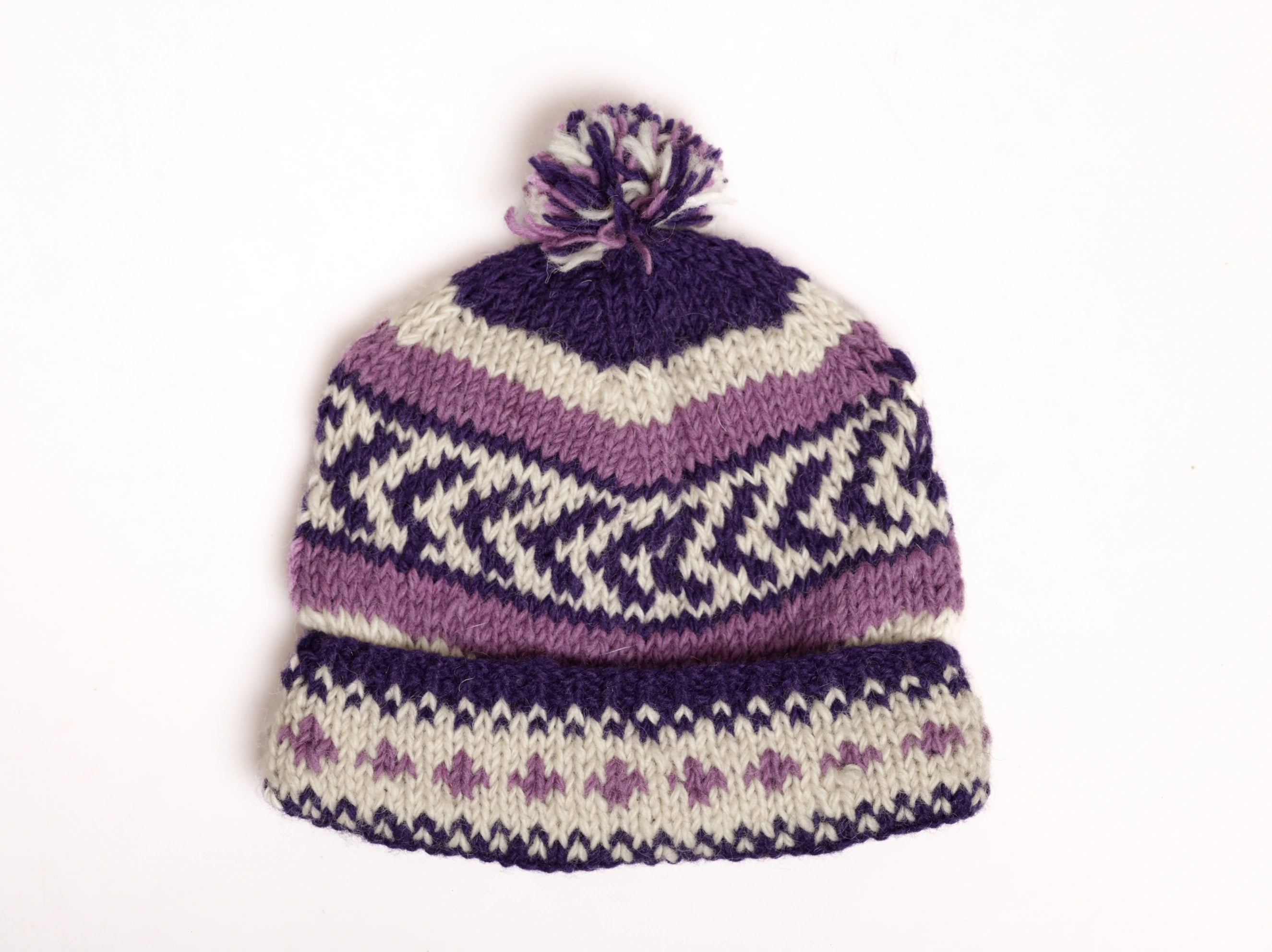 Knitted hat with purple and white pattern on a white background