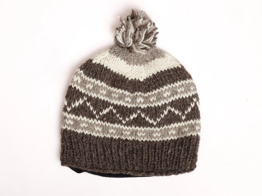 Knitted beanie with grey pattern and a pom-pom on a white background