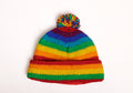 Colorful striped beanie with a pom-pom on a white background