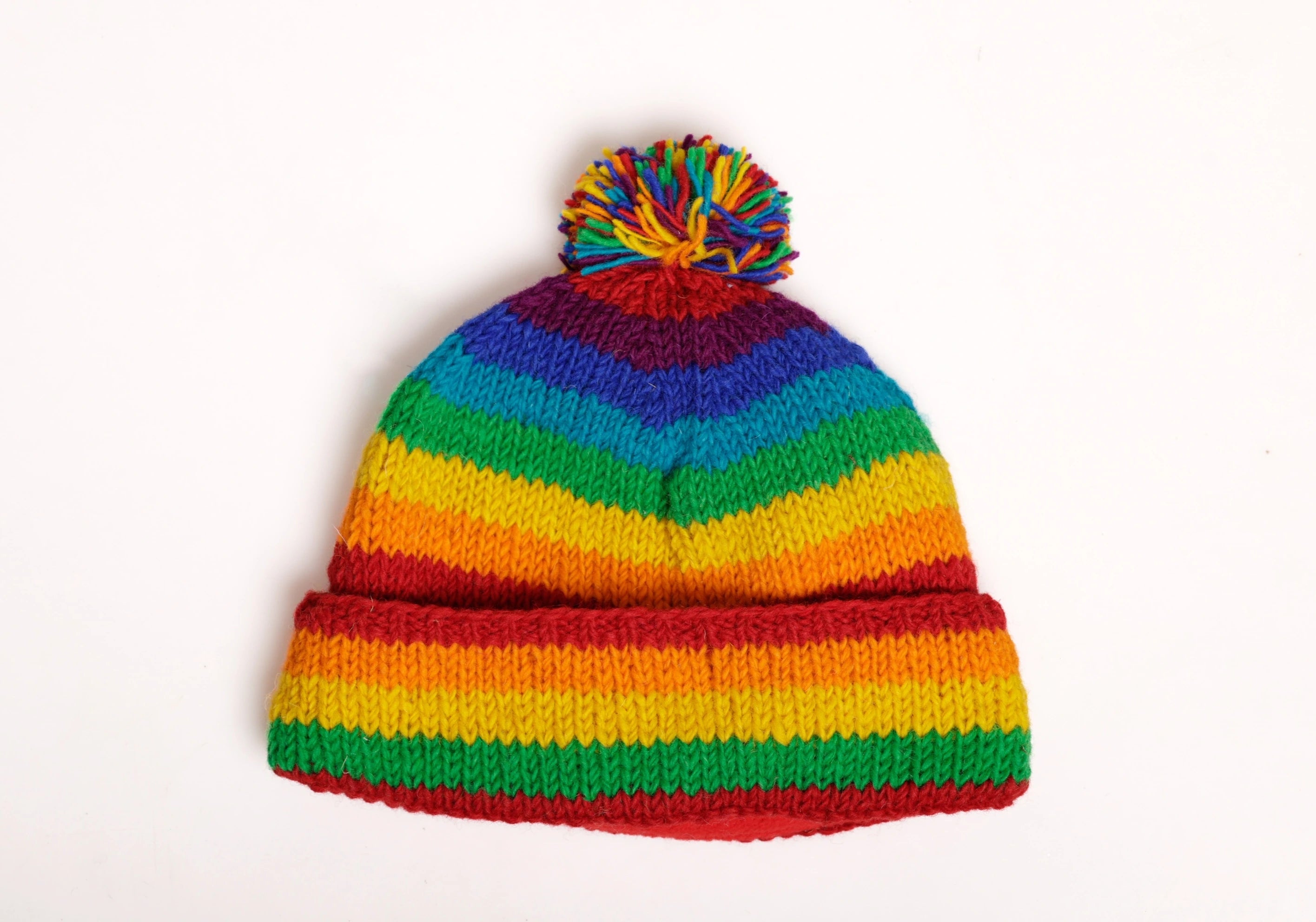 Colorful striped beanie with a pom-pom on a white background