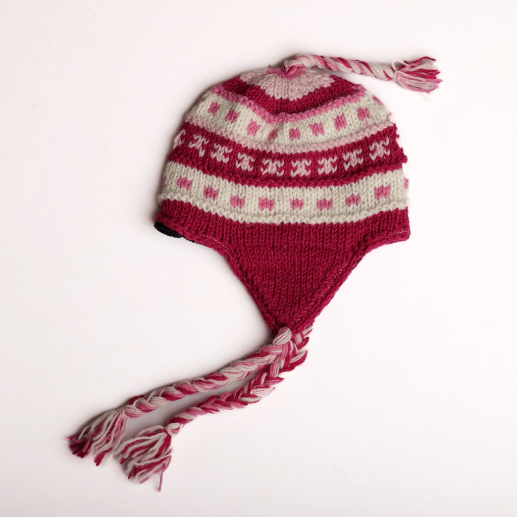 Knitted hat with pink and white pattern on a white background