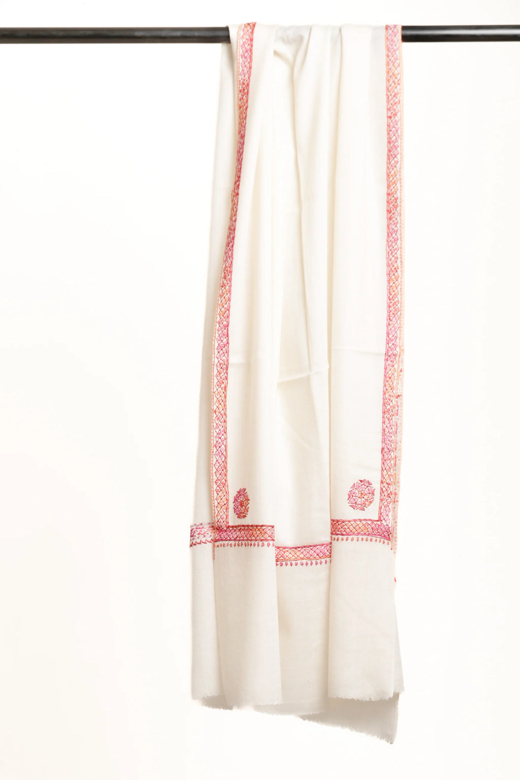 White scarf with pink embroidery on a black rod