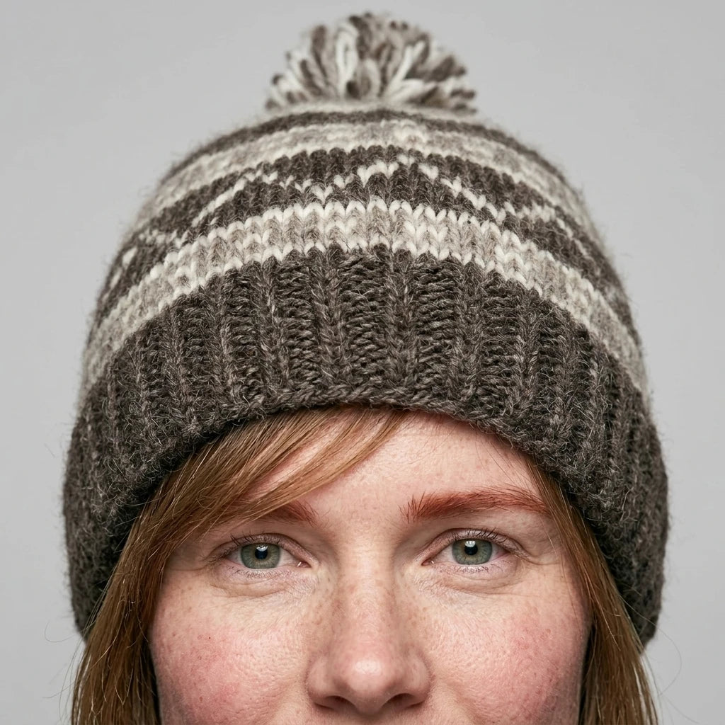 Pom-pom knit beanie — On Model - Close-up Detail | Generated by Modelize