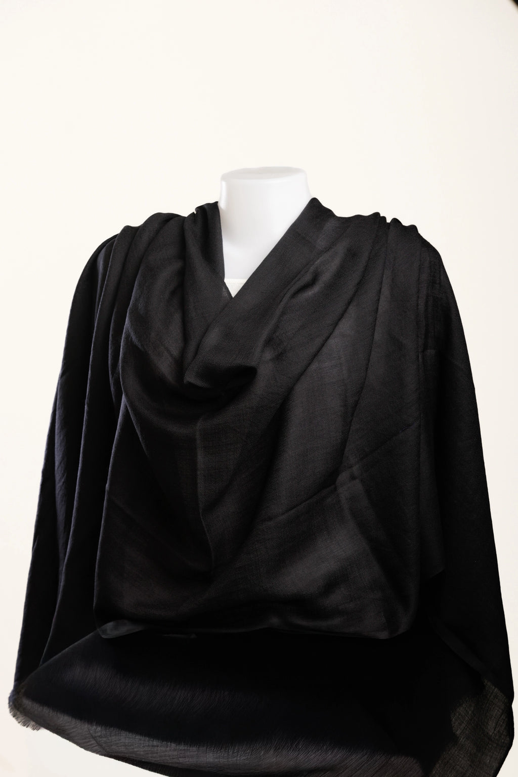 Black scarf draped over a mannequin on a white background