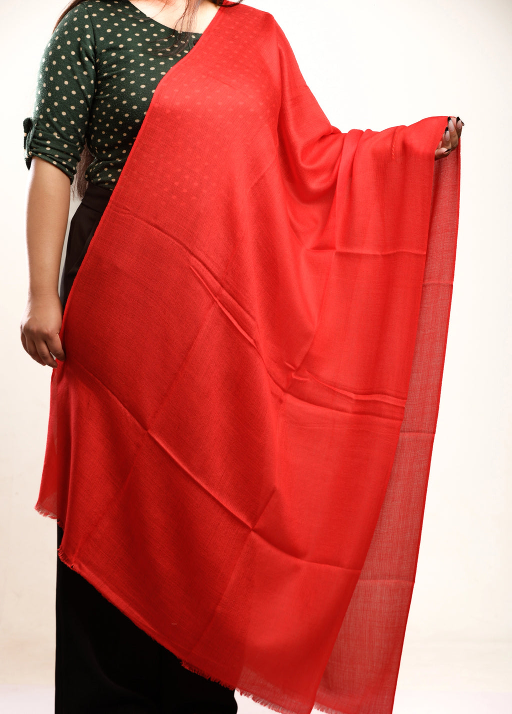 Red scarf draped over a person on a white background