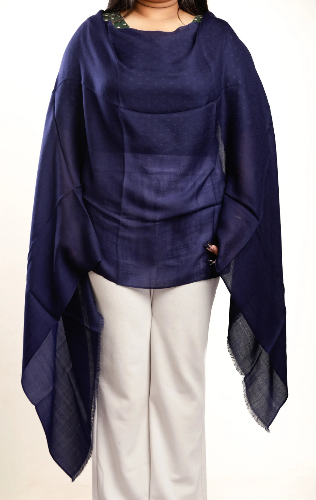 Navy blue poncho draped over a person on a white background