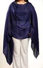 Navy blue poncho draped over a person on a white background