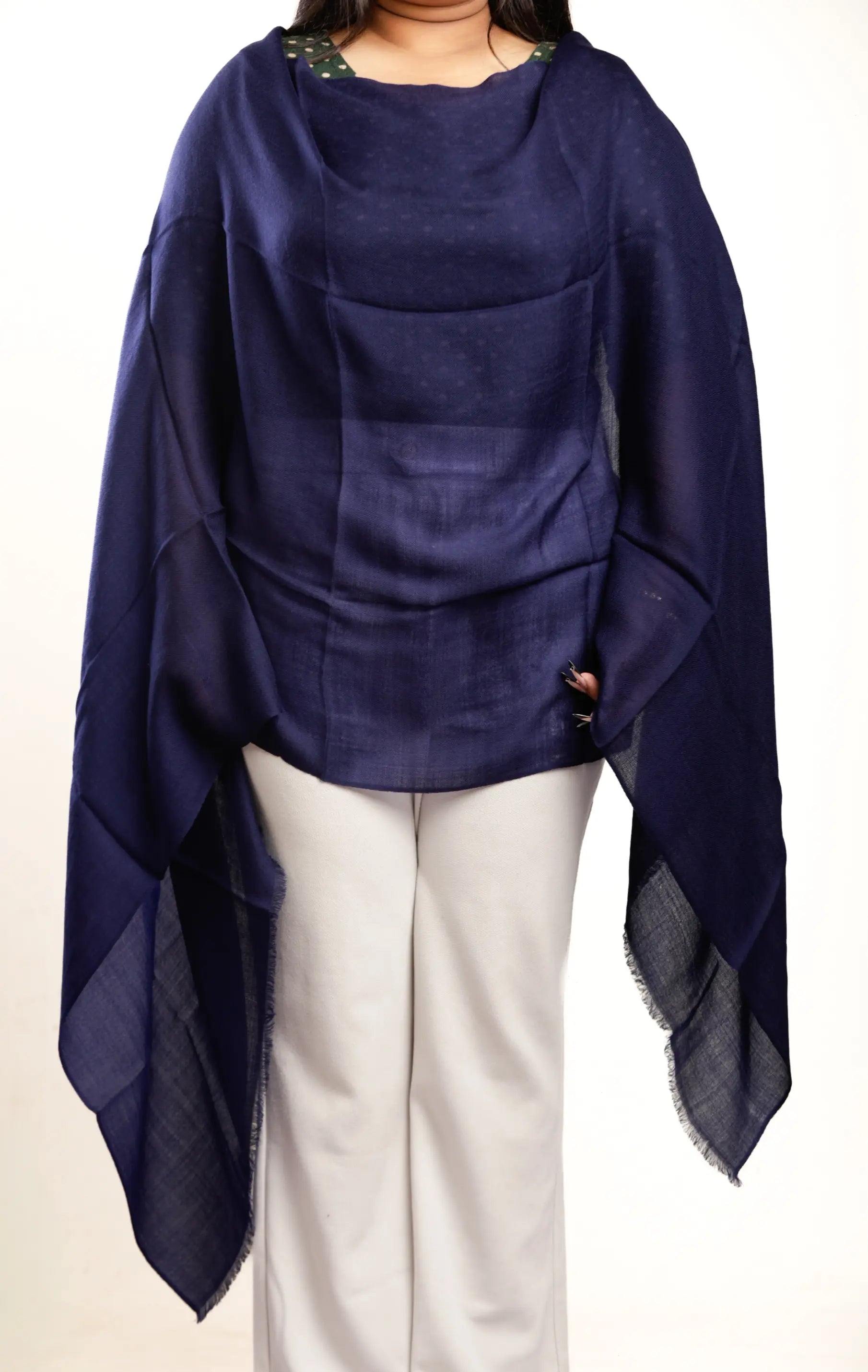 Navy blue poncho draped over a person on a white background